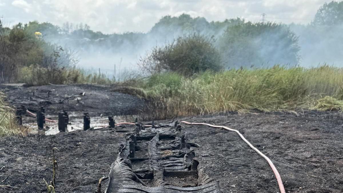 A muddy field with large smoke coming out of it