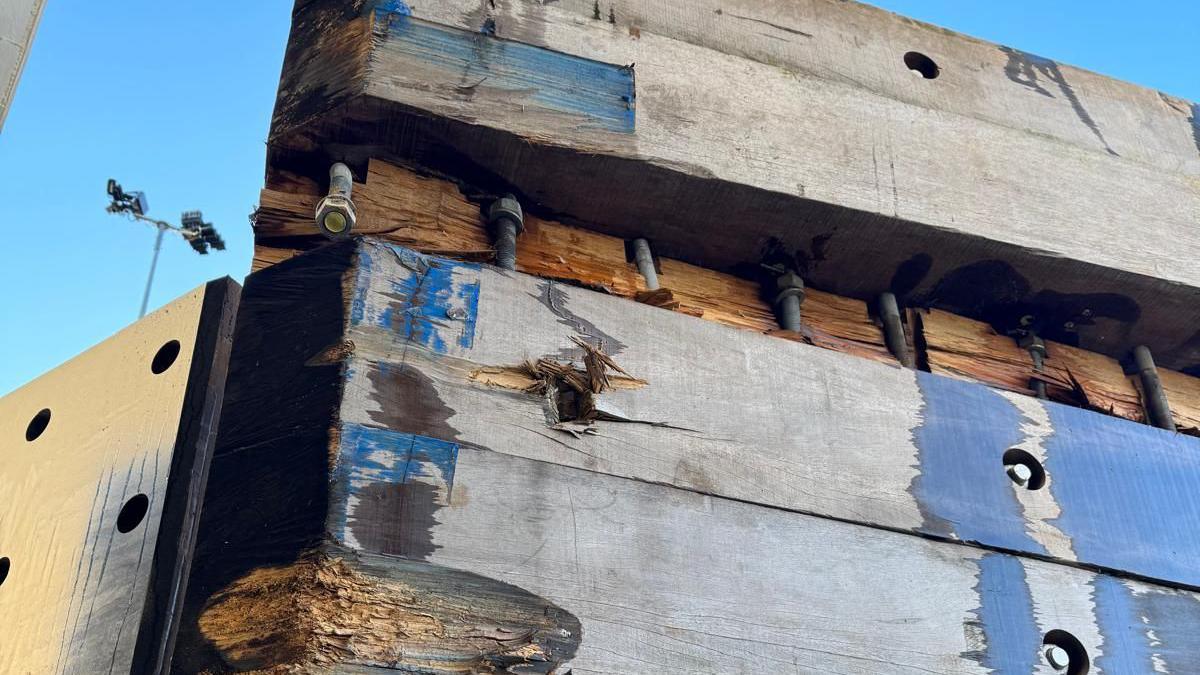 Large sleeper-like timbers on the ferry berth. One of the timbers is missing and the others are damaged.