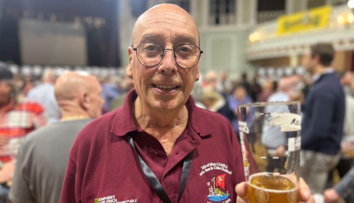 Roger Cave holding a pint