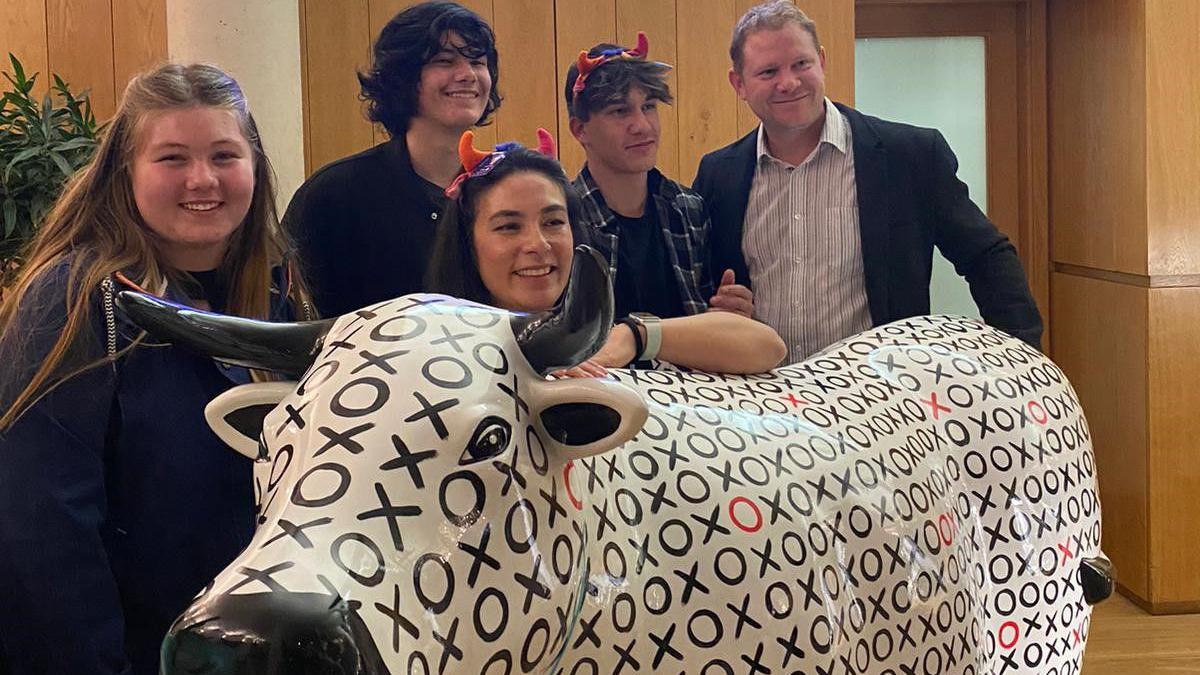 Os and X's, white and black ox sculpture with artist Judy Guillery and family