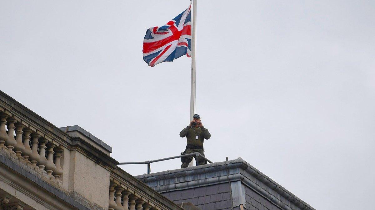 Armed police can be seen on rooftops