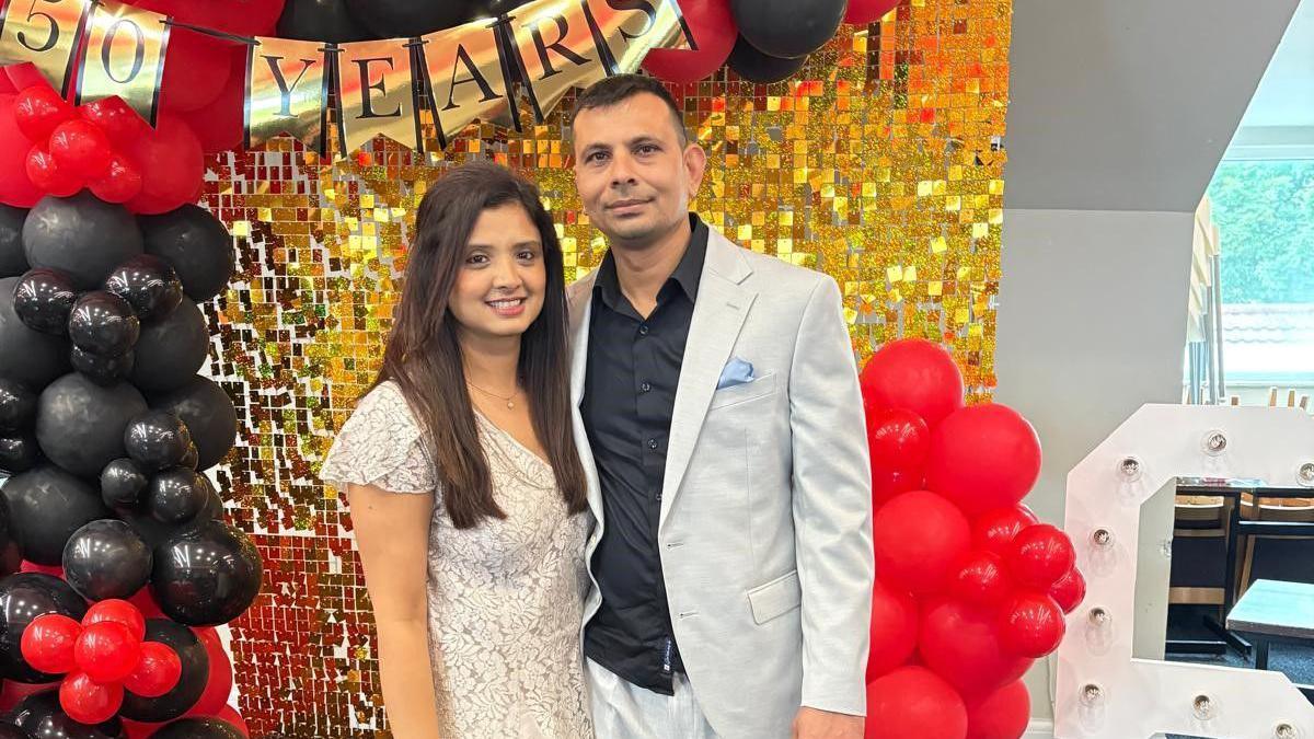 Ketan Shah alongside his wife Megha at a celebration both are dressed smart