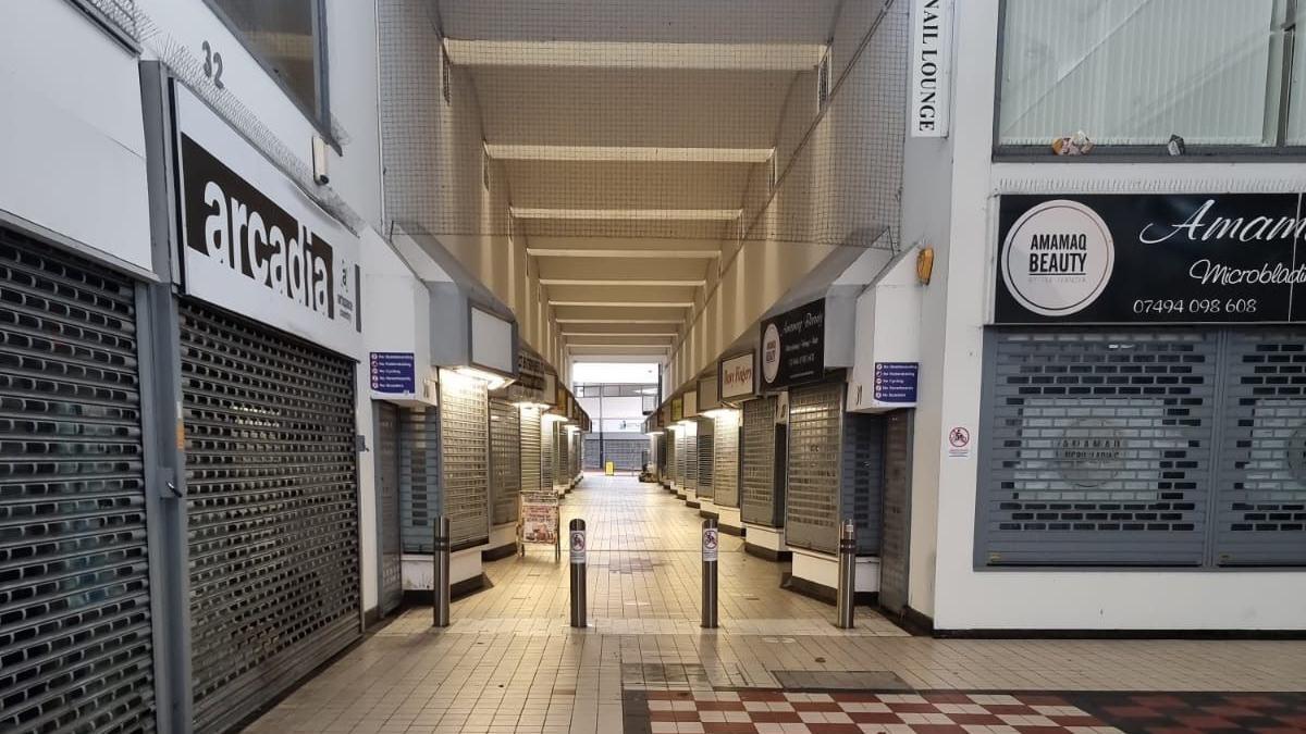 Closed shops with the shutters up in Coventry Arcade