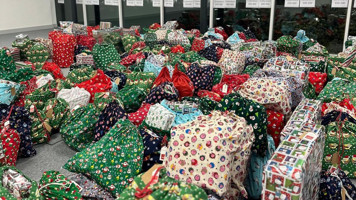 A selection of wrapped up presents organised in a large room. 