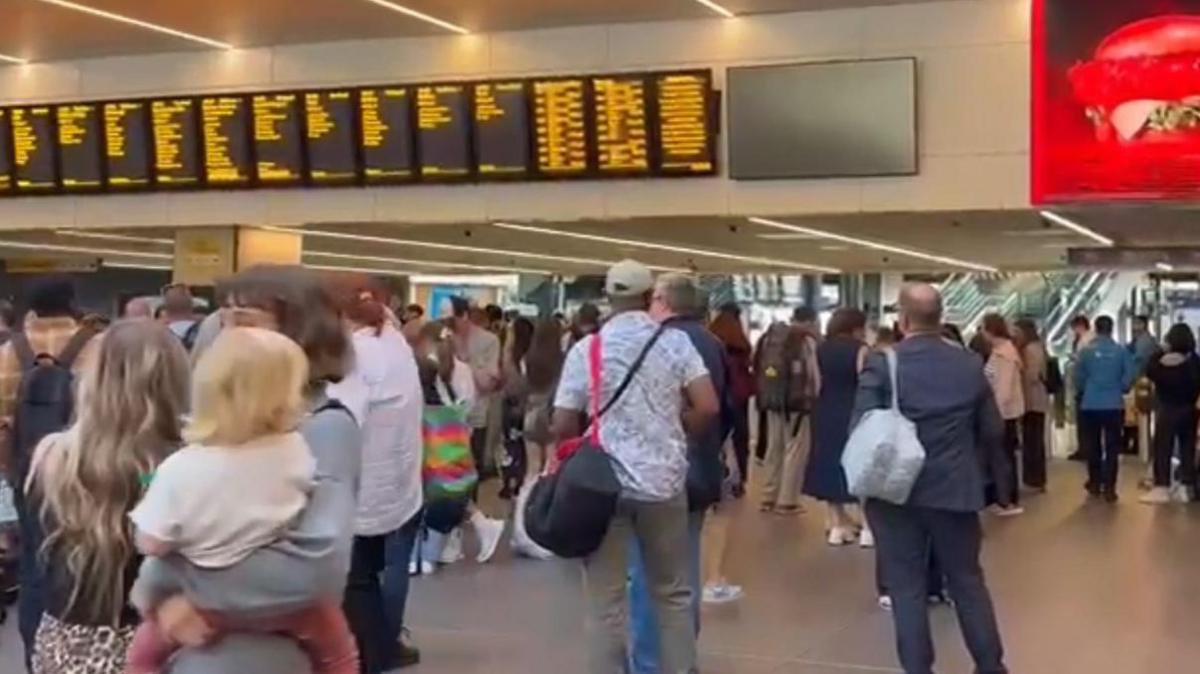 People waiting at a railway station.