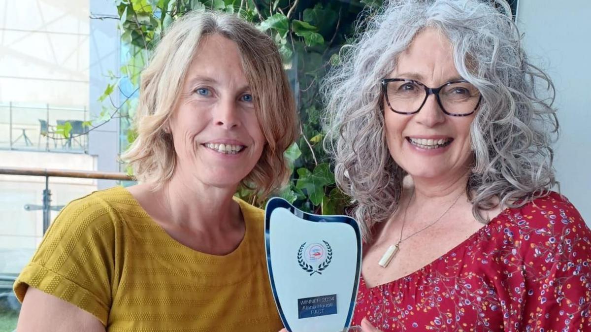 Kathryn Warner and Lynda Souter holding the award