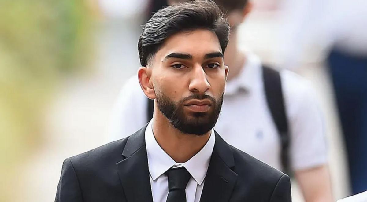 Mohammed Fahir Amaaz with black hair and beard and wearing a black suit arrives at Liverpool Crown Court.