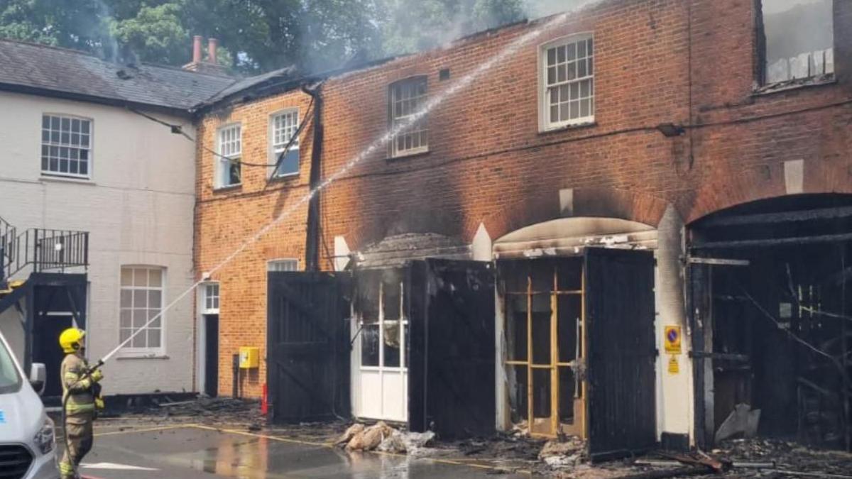 A firefighter tackling the fire at The Stables, Tidworth