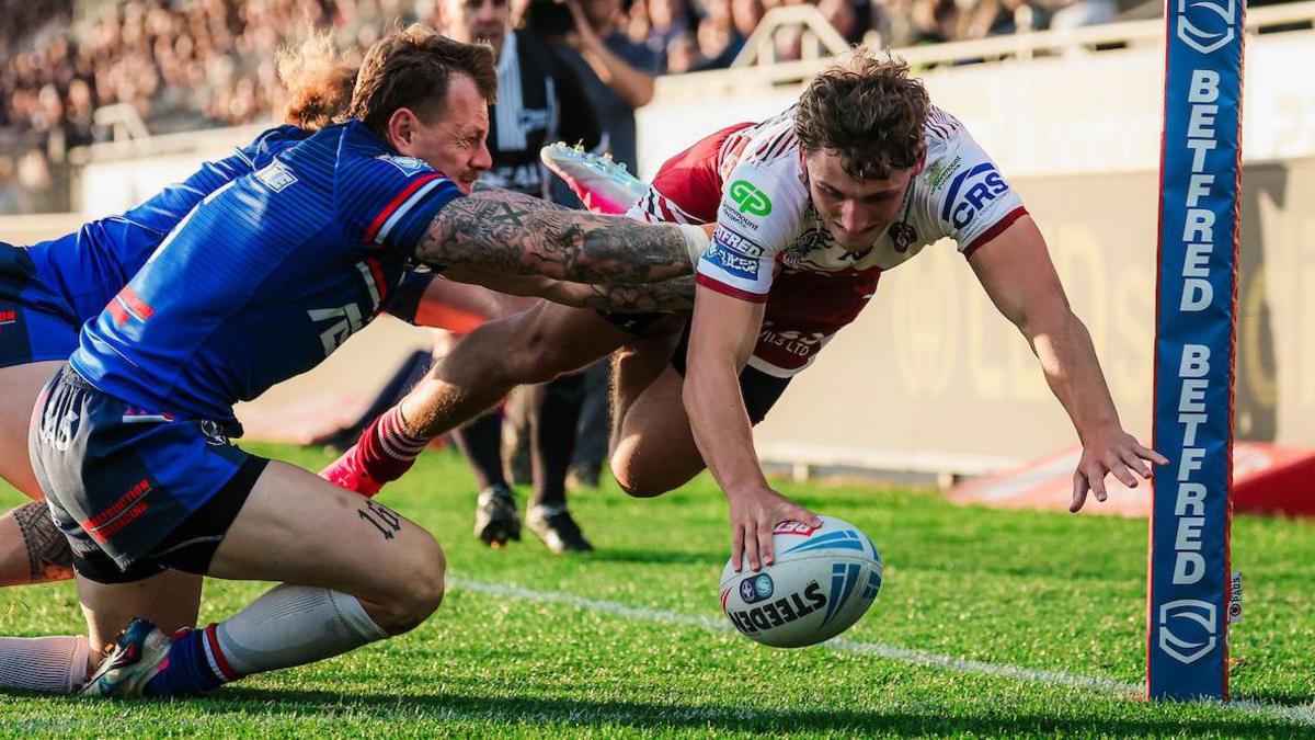 Wigan Warriors winger Noah Hodkinson dives to get the ball down in the corner 