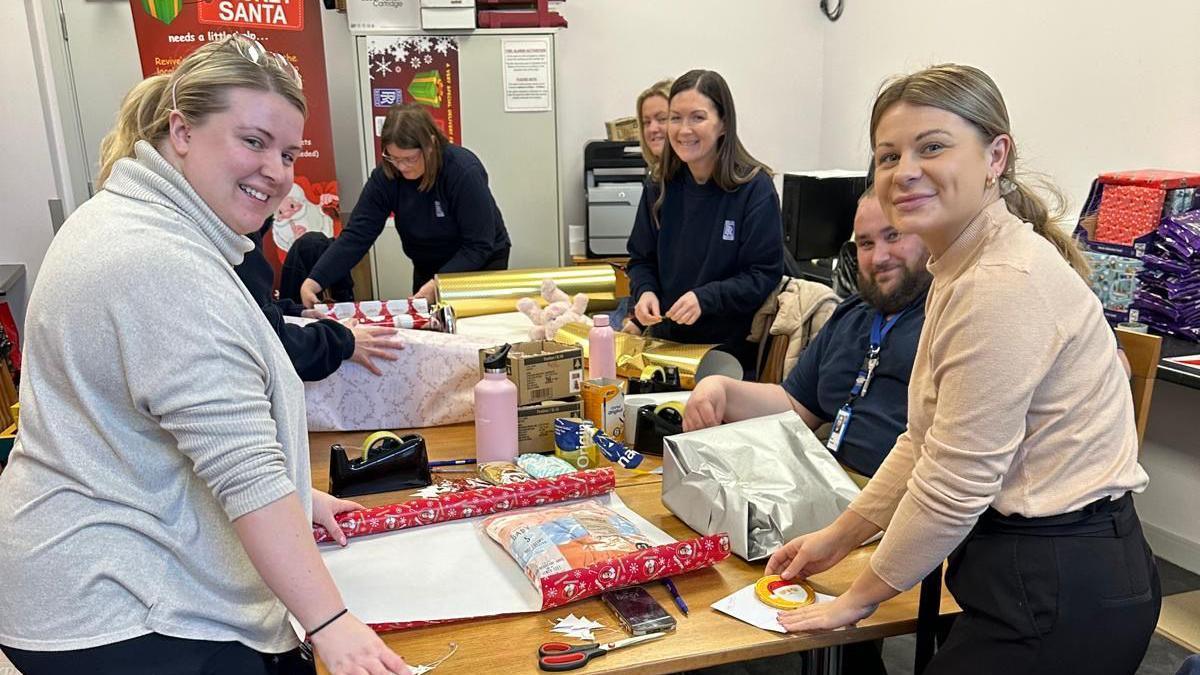 Volunteers wrapping gifts 