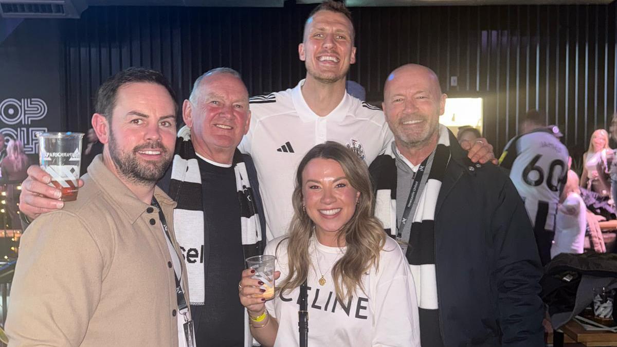 Alan Shearer (far right) and his daughter Chloe celebrate with Newcastle goalscorer Dan Burn (second from right)