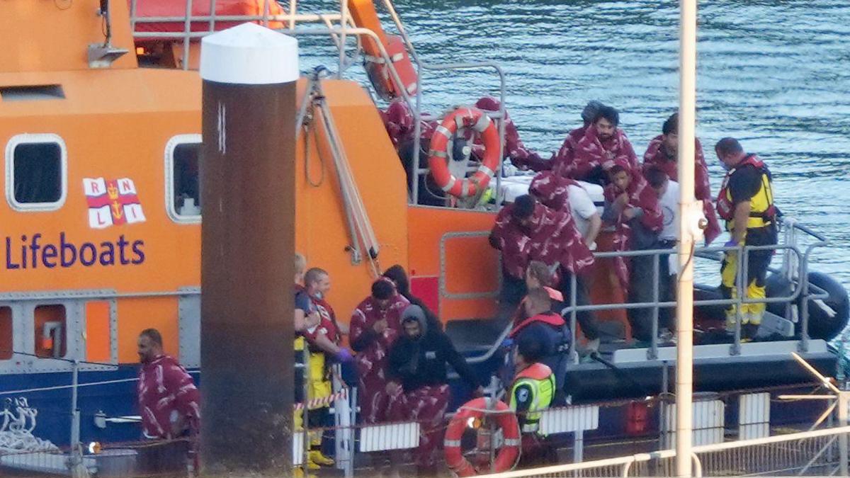 A group of people thought to be migrants are brought to Dover in Kent from the RNLI lifeboat on Saturday