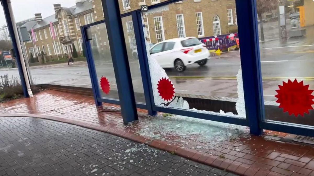 A smashed glass pane outside New Again Auto Reconditioning