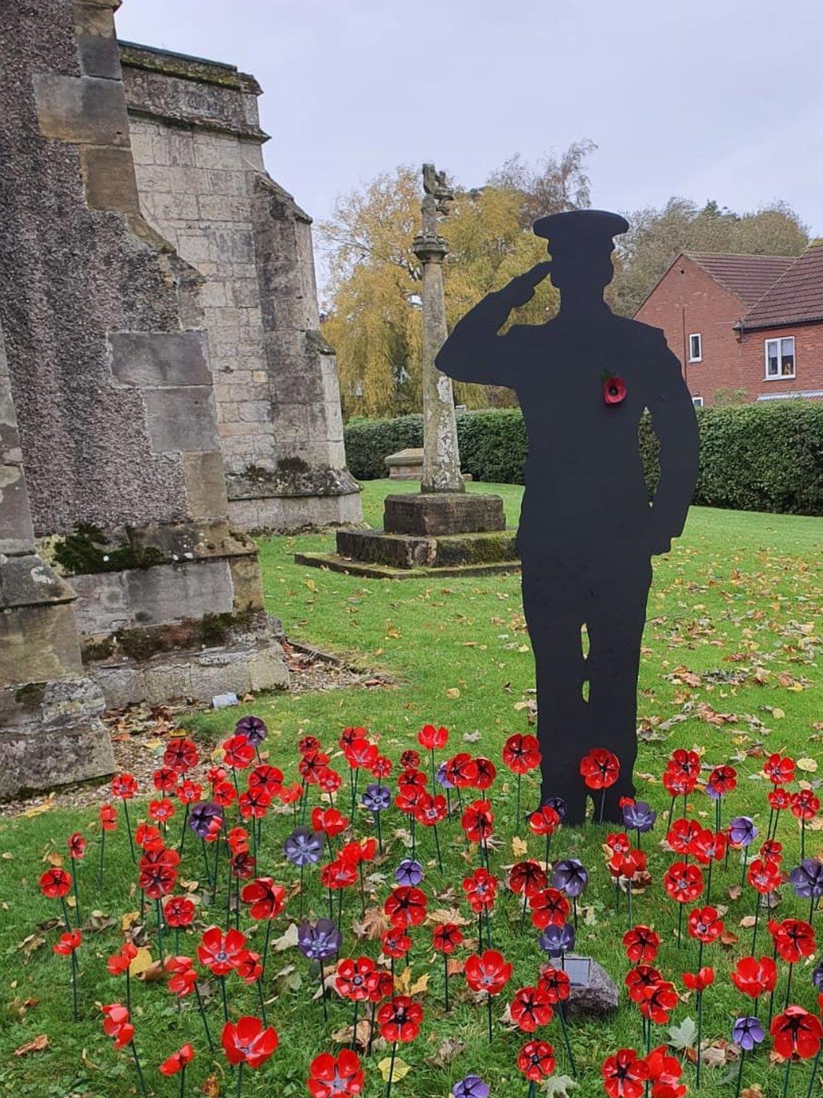 One of the silhouettes depicts a saluting Navy officer