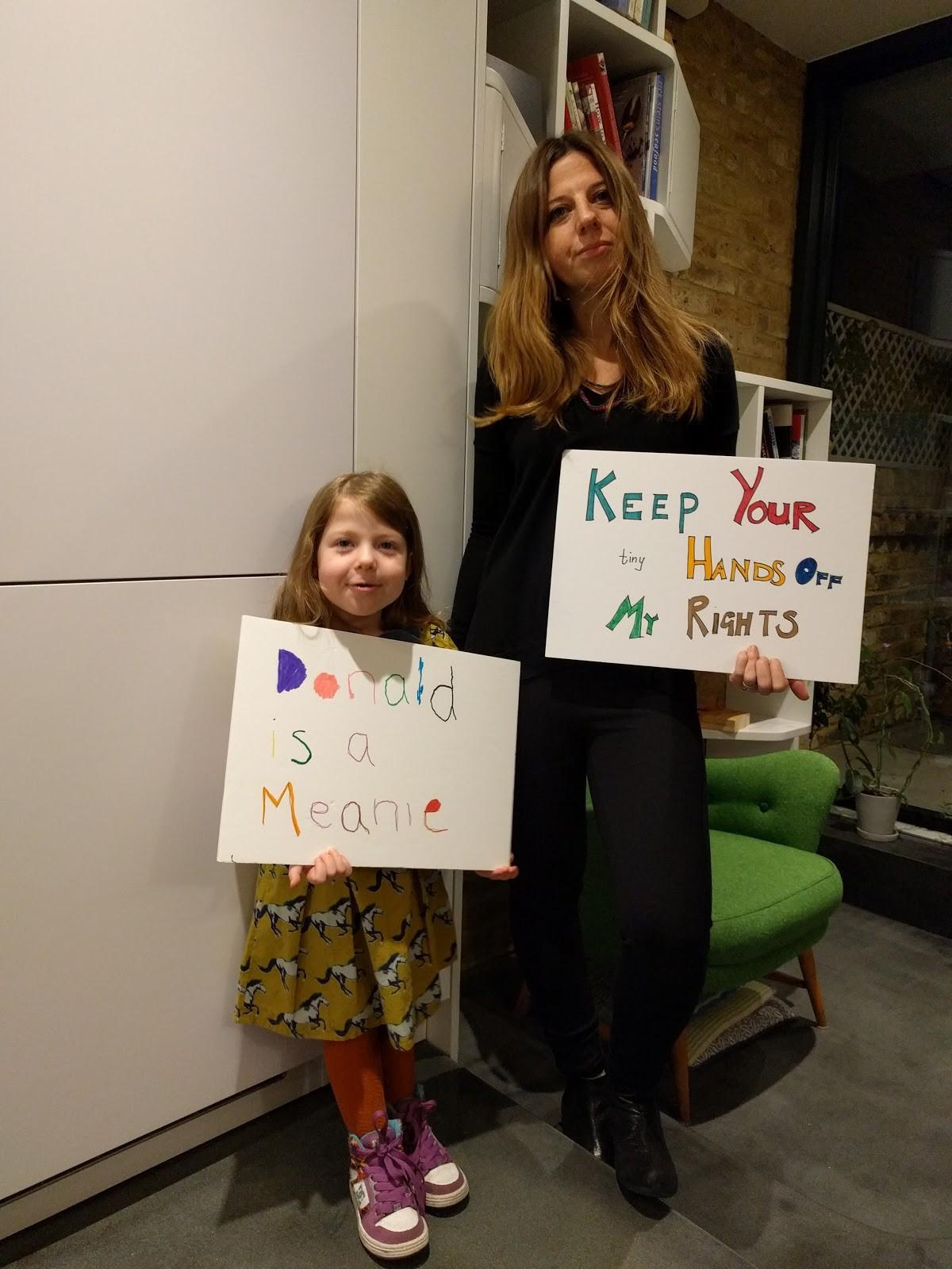 Erica Wald with her daughter holding banners