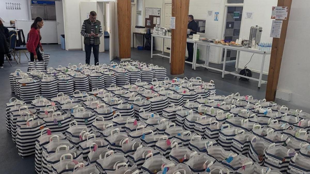 Hampers packaged by the Diwali Basket Brigade laid out across the floor.