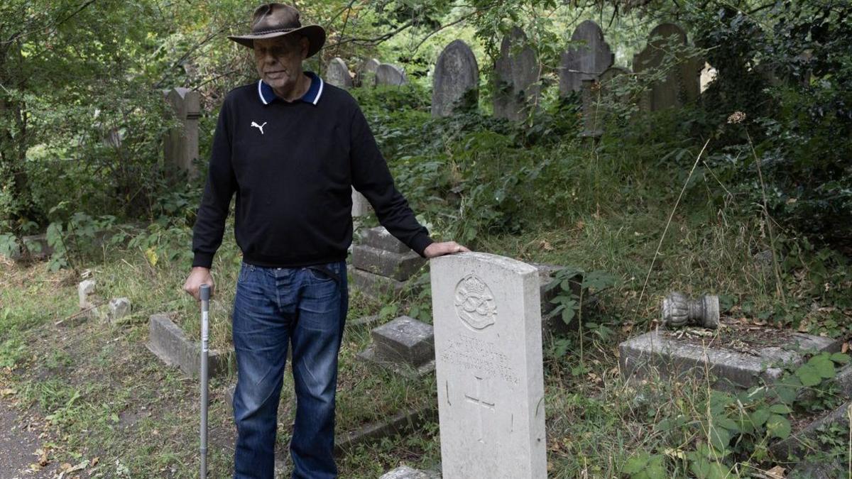 Mick is the Friends' Great War Coordinator, he stands by a grave