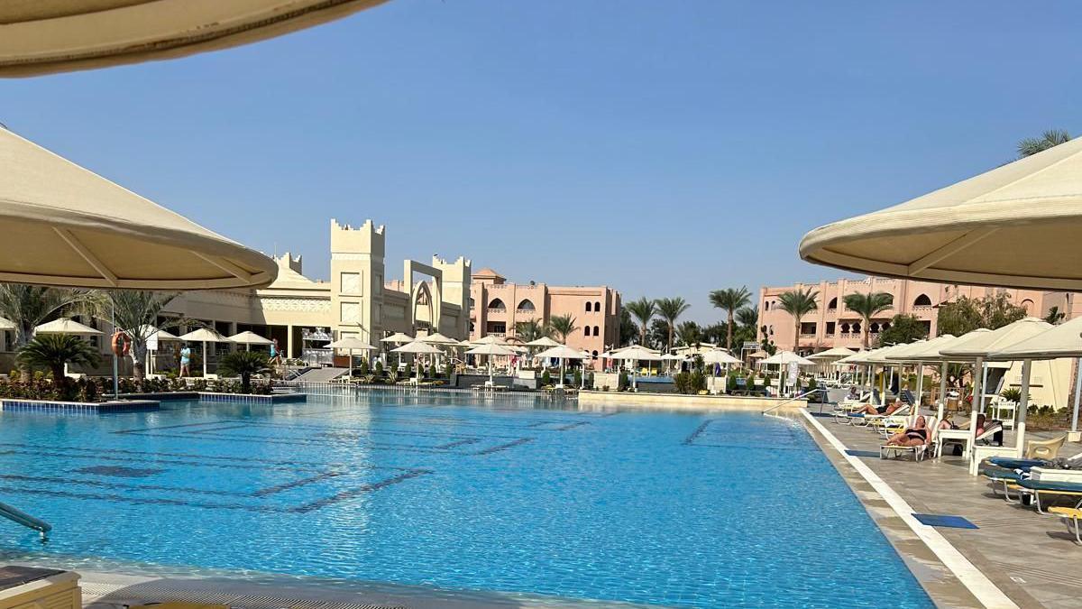 A pool area showing a blue sky and seats