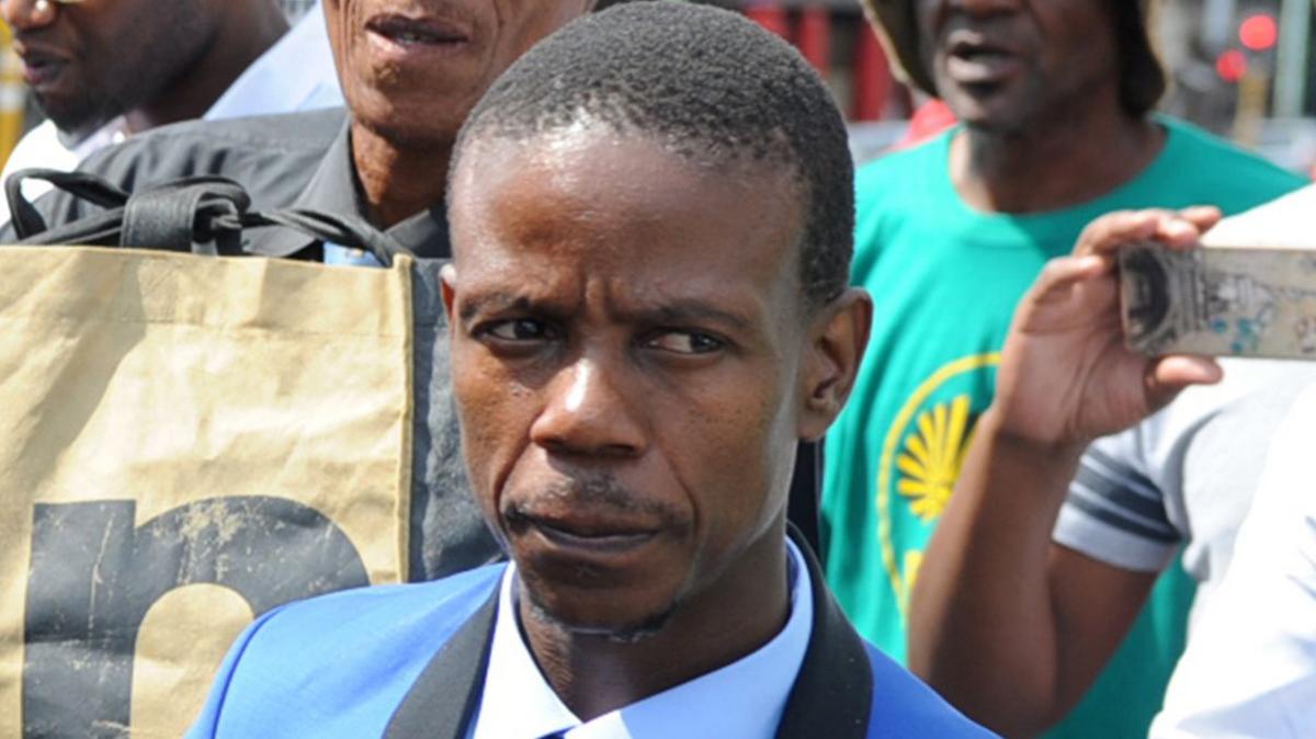 A close-up shot of Paseka Motsoeneng, known as Pastor Mboro, in a blue suit