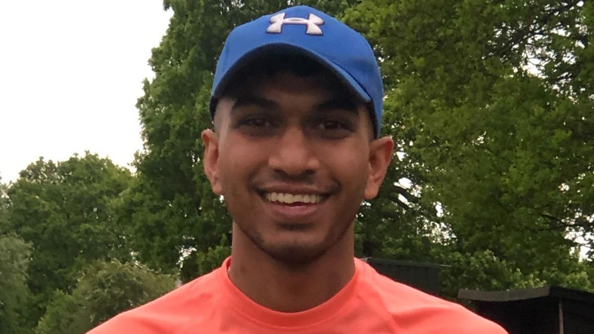 A young man in a baseball cap