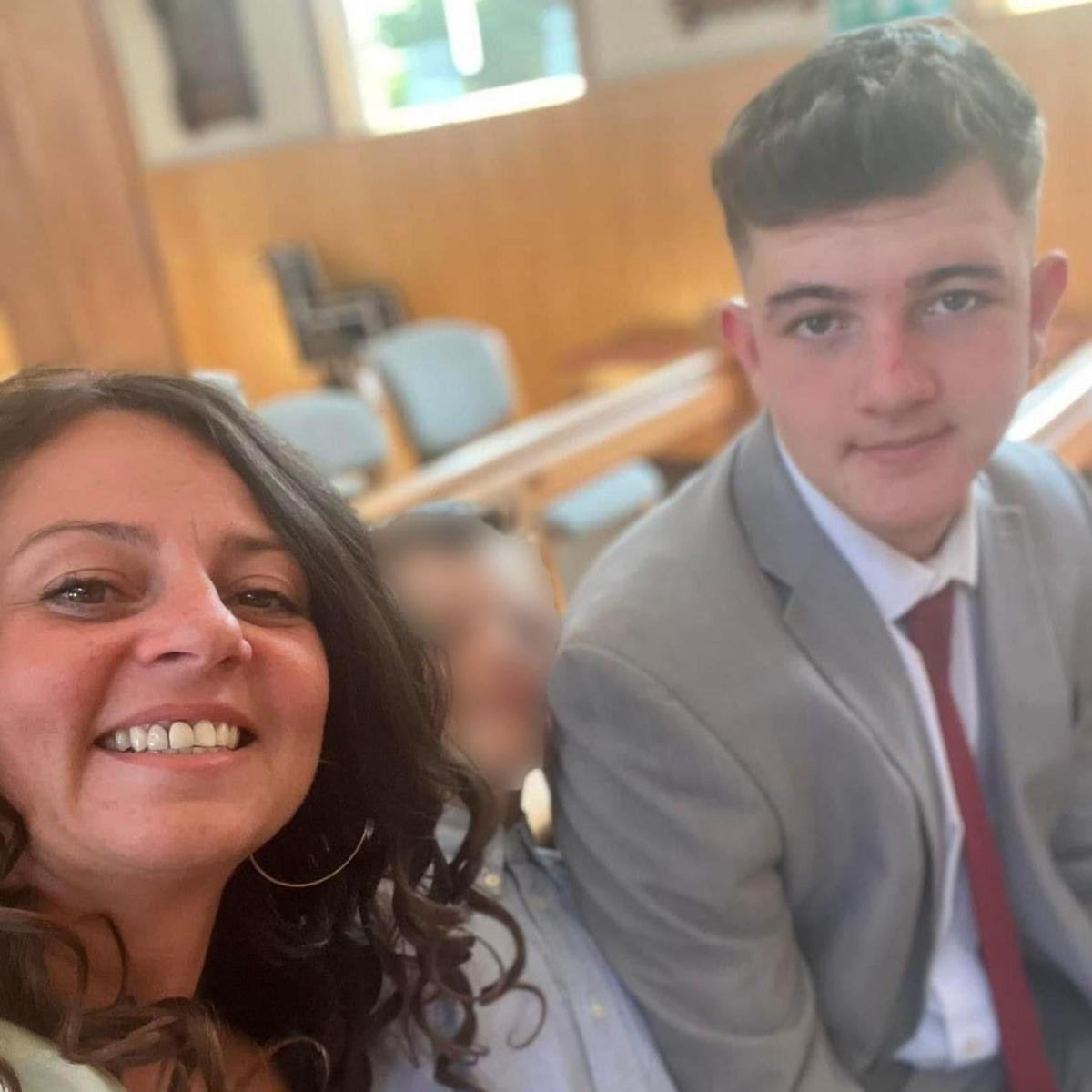 A selfie of Wendy and Cole, who is wearing a grey suit, white shirt and a burgundy tie
