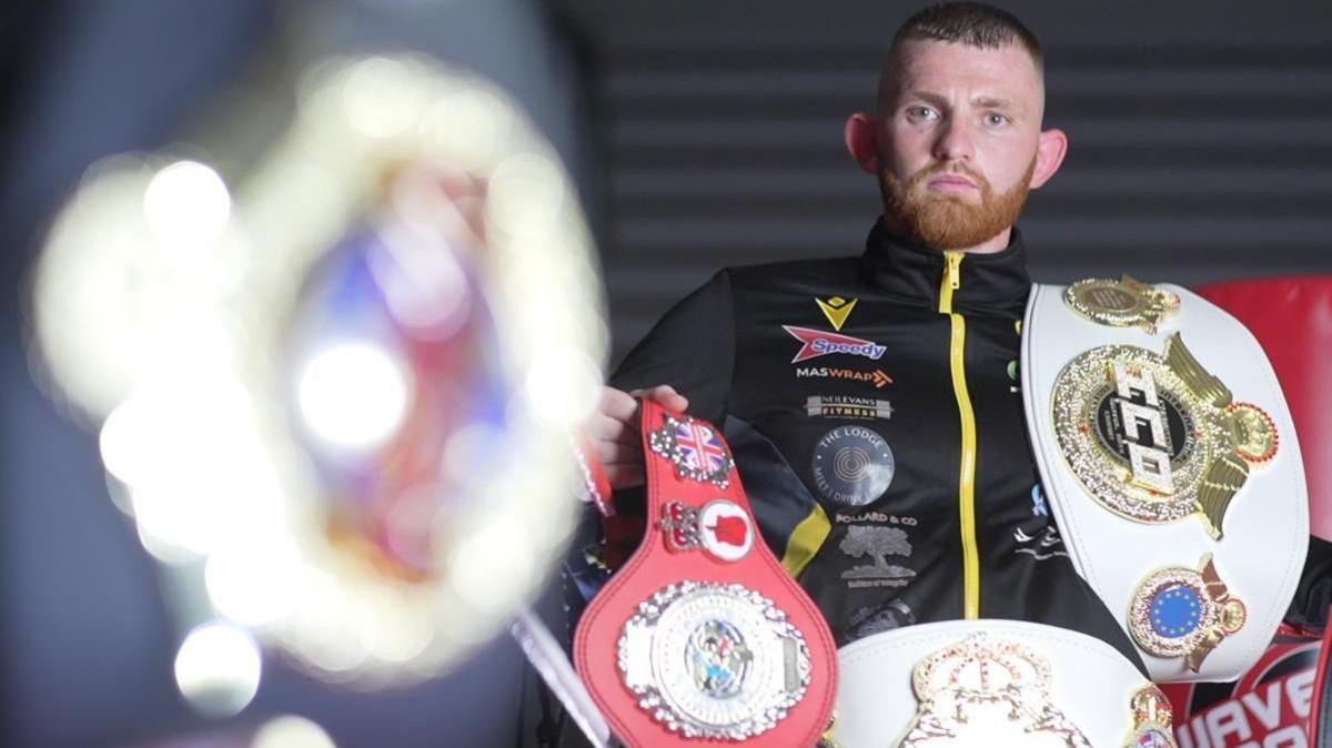 Leon Dunnett with his kickboxing title belts