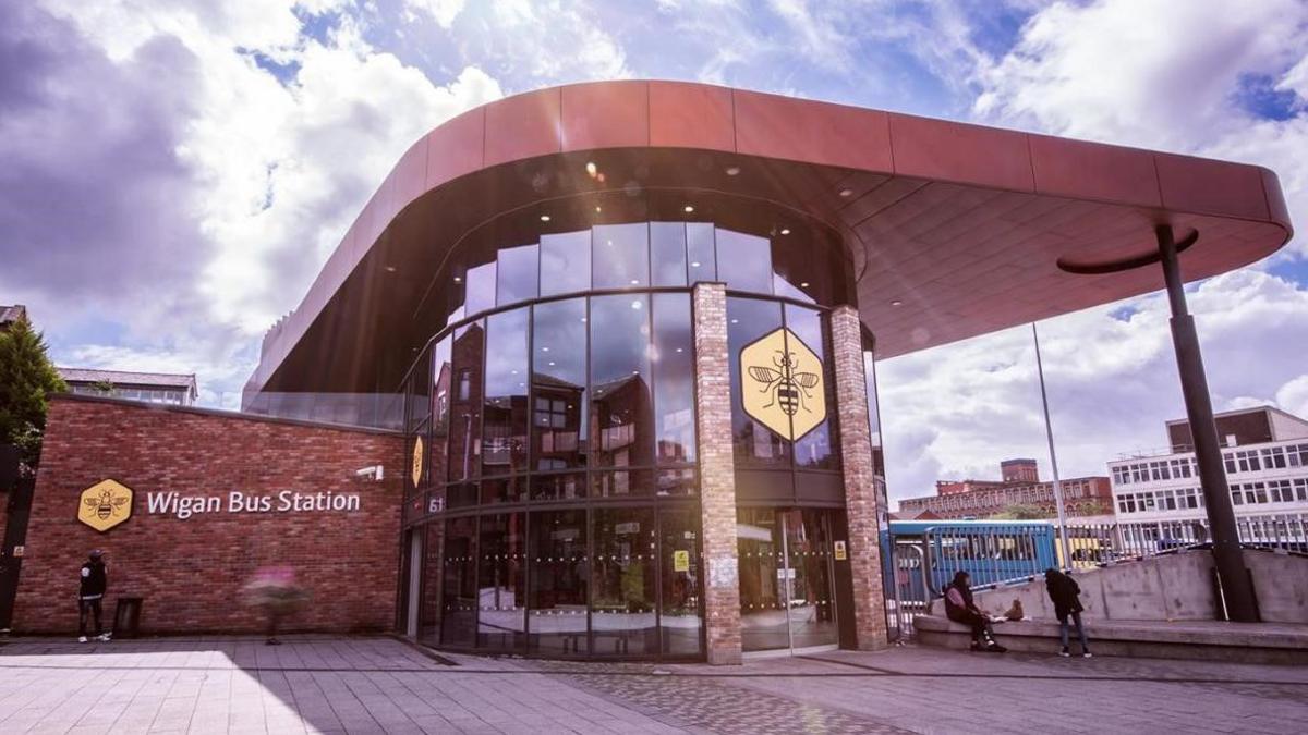 exterior of Wigan bus station's entrance with its round glass front