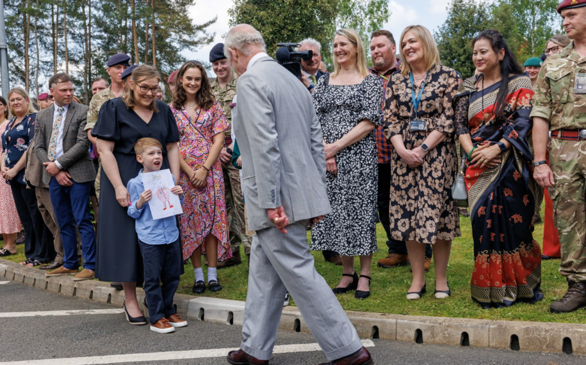 King Charles III is shown of a drawing of the King by Louie bacon, six, during a visit to Gibraltar Barracks in Minley, Hampshire