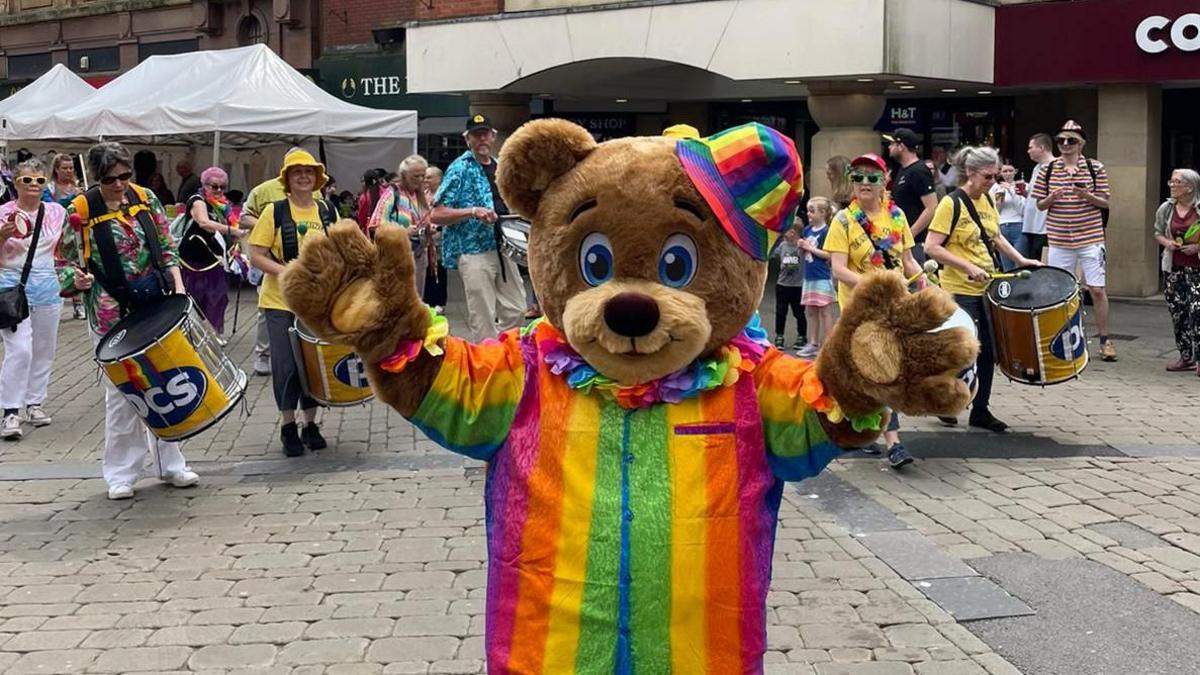 Bear in rainbow suit during pride parade