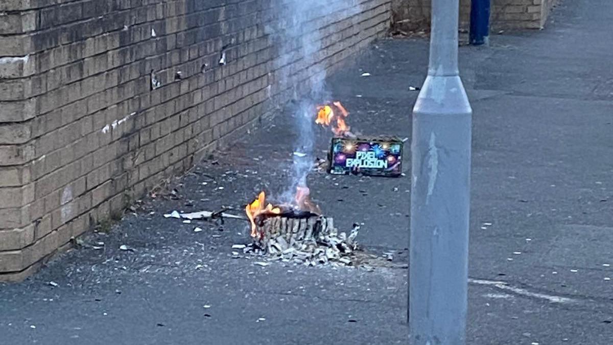 Two discarded firework boxes on fire