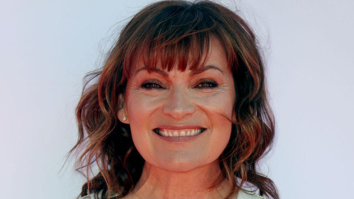 Lorraine Kelly has shoulder length brown hair with a fringe. She smiles at the camera.