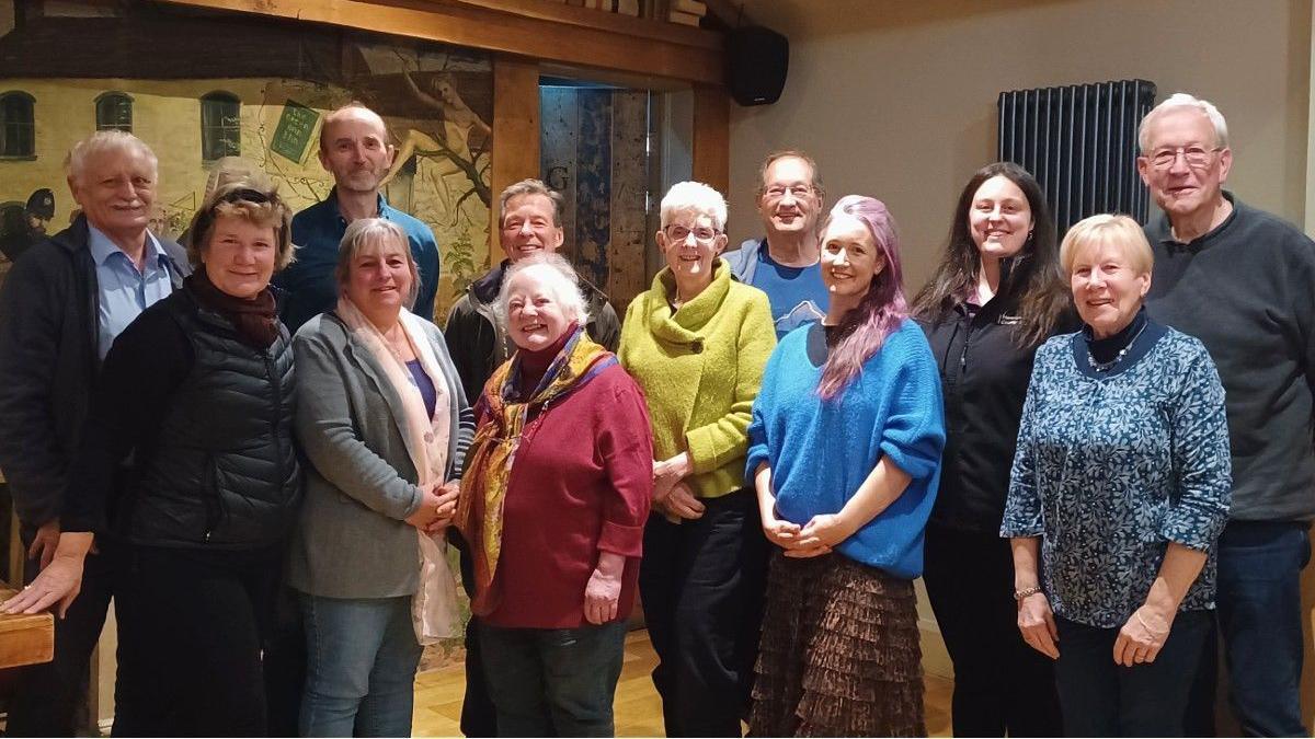 Representatives of the groups involved in Dark Skies Herefordshire project. There are 12 people looking at the camera and smiling. 