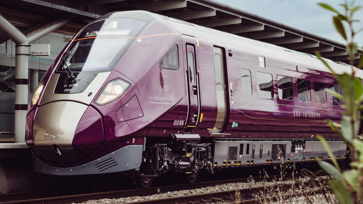 The front of a purple East Midlands Railway train on the track 