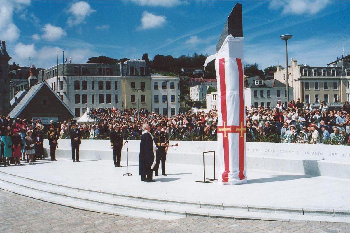 Prince Charles unveiling the Liberation Monument with a crowd watching on.