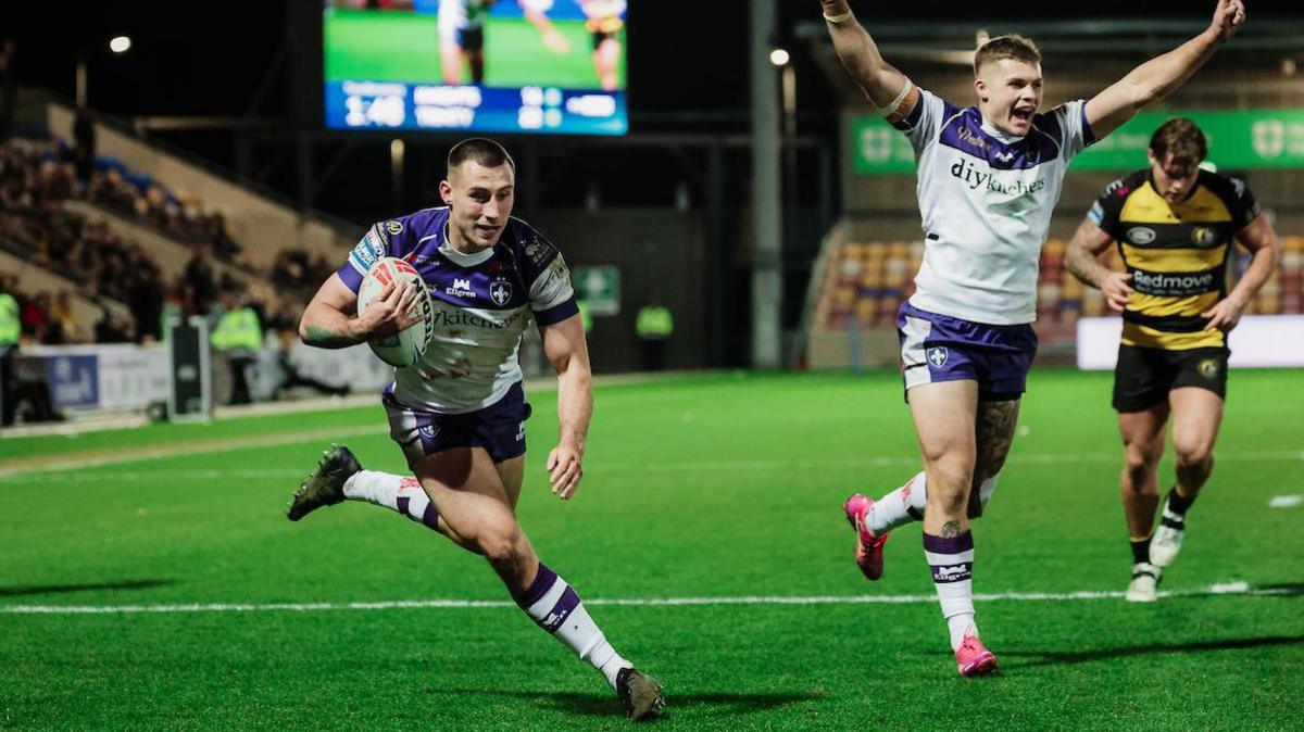 Oli Pratt runs the ball in for his second try as team-mates celebrate in the background