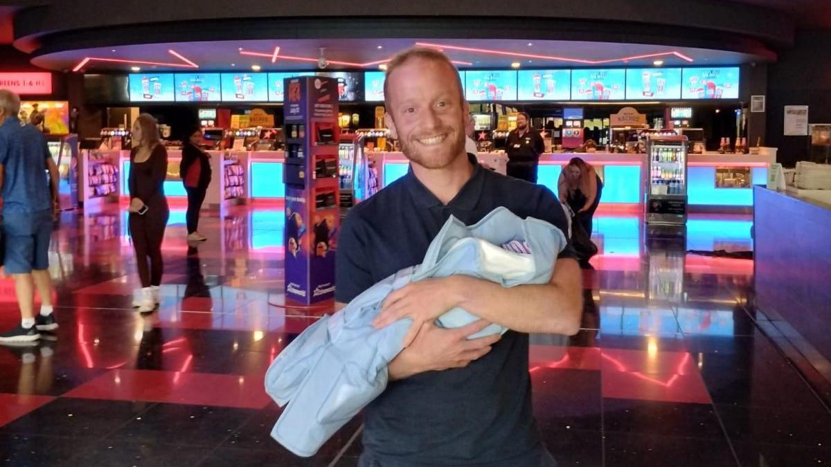 Gareth Miles with his baby daughter in Cineworld