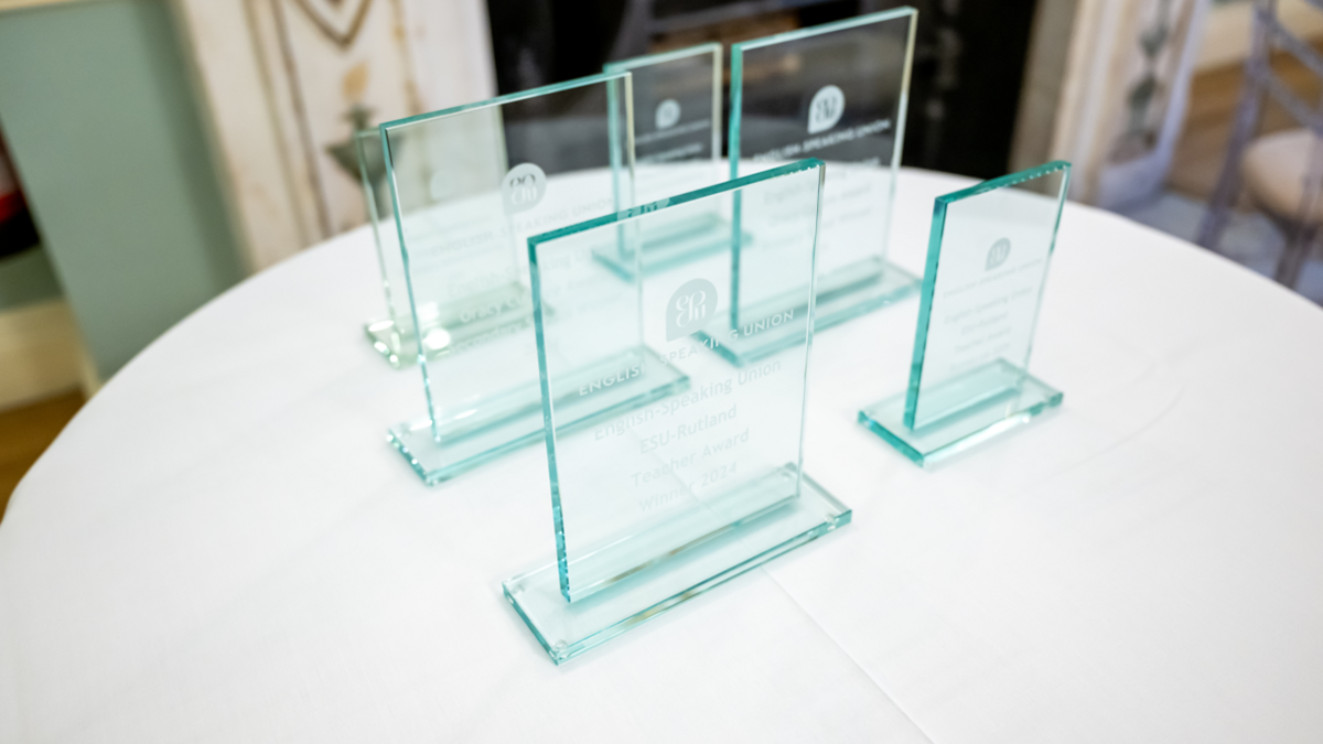 Rectangle glass awards placed on a round table with a white cloth