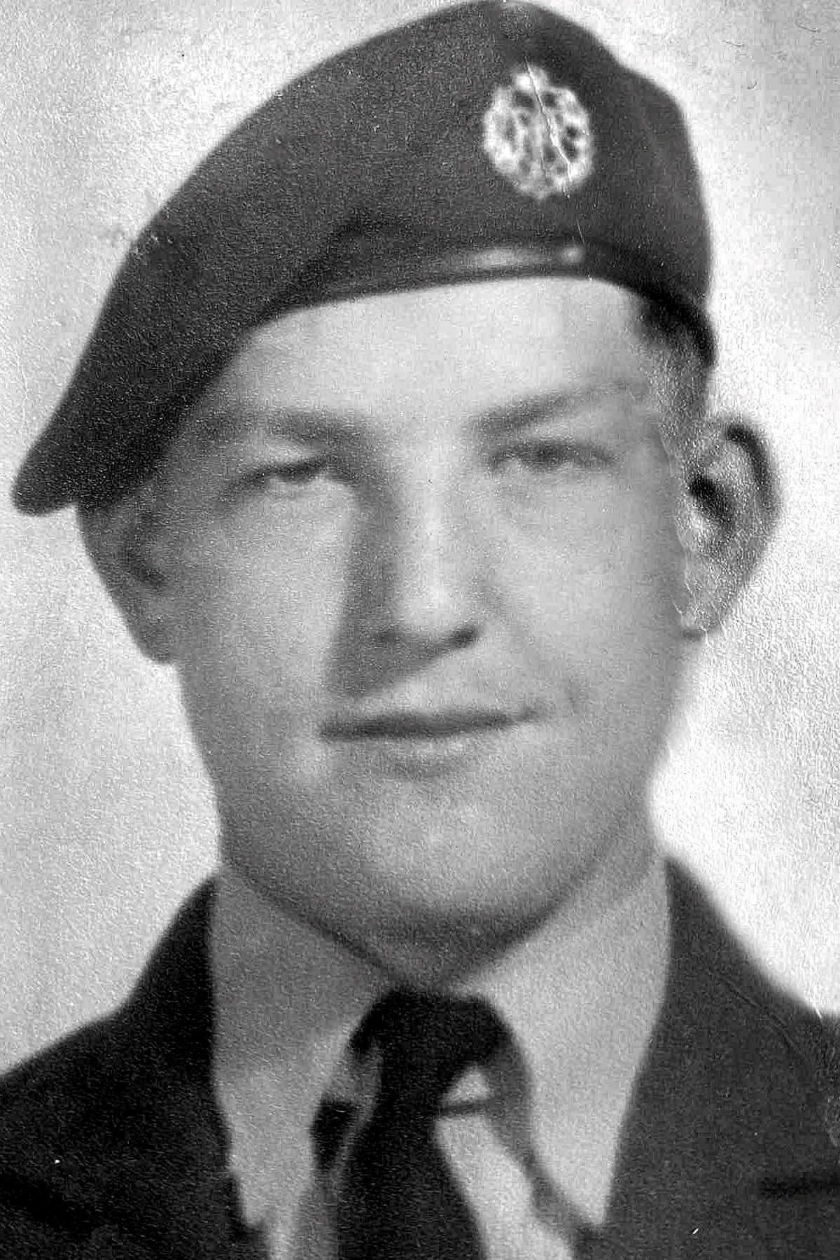 Black-and-white headshot of Mr Gray wearing his RAF uniform and cap. He is looking directly into the camera.