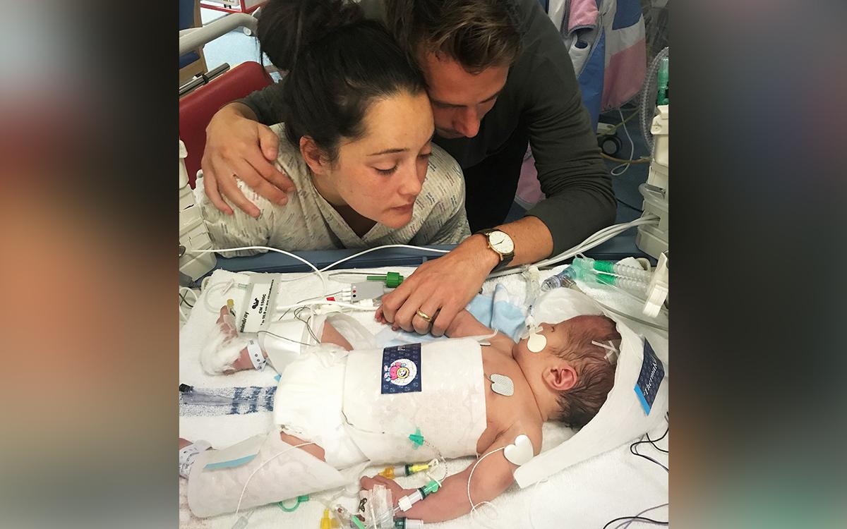 Parents Sarah and Tom at the bedside of Harry