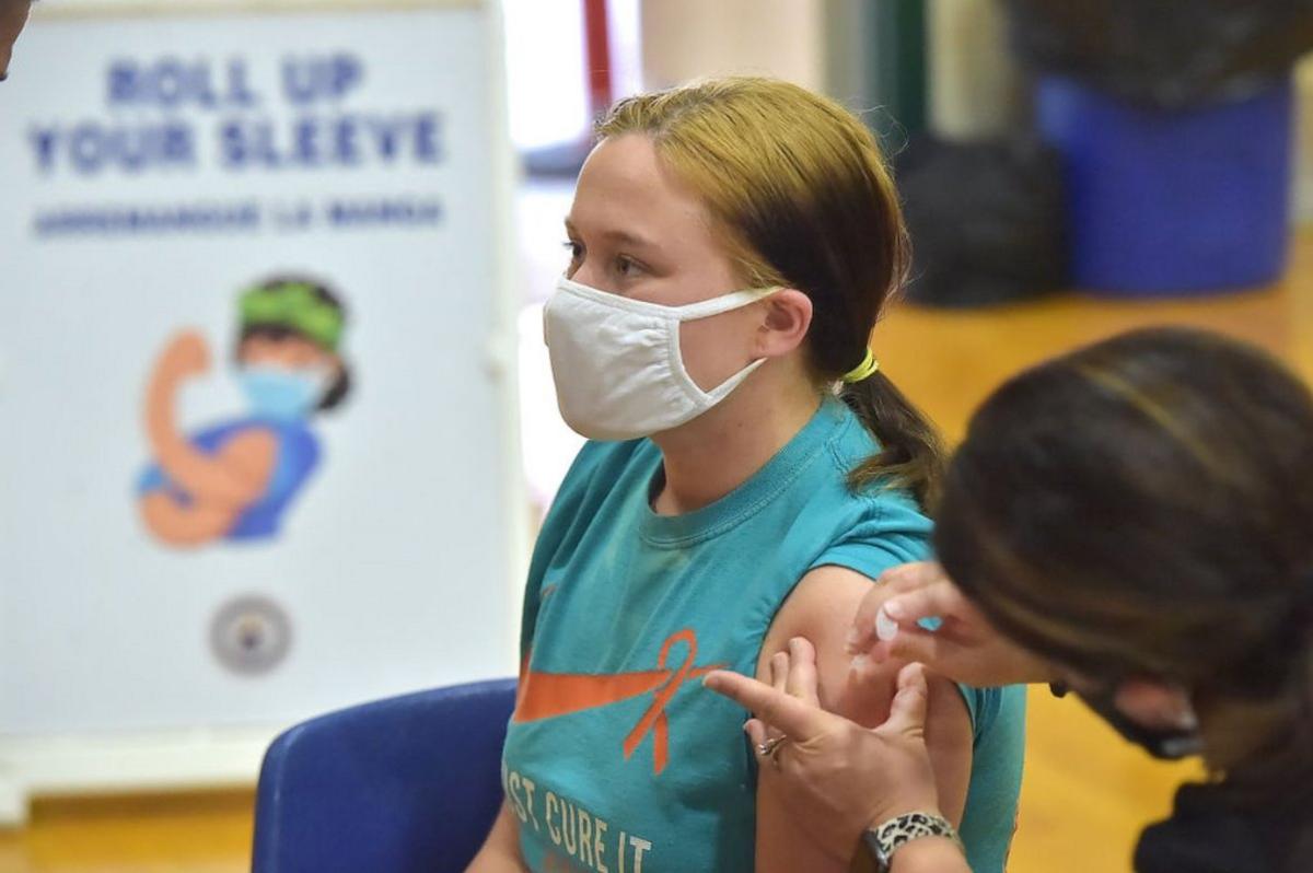 Molly Day gets her first Pfizer Biontech COVID vaccine at Ridley High School Monday afternoon May, 3, 2021 as part of a clinic for students age 16-18.