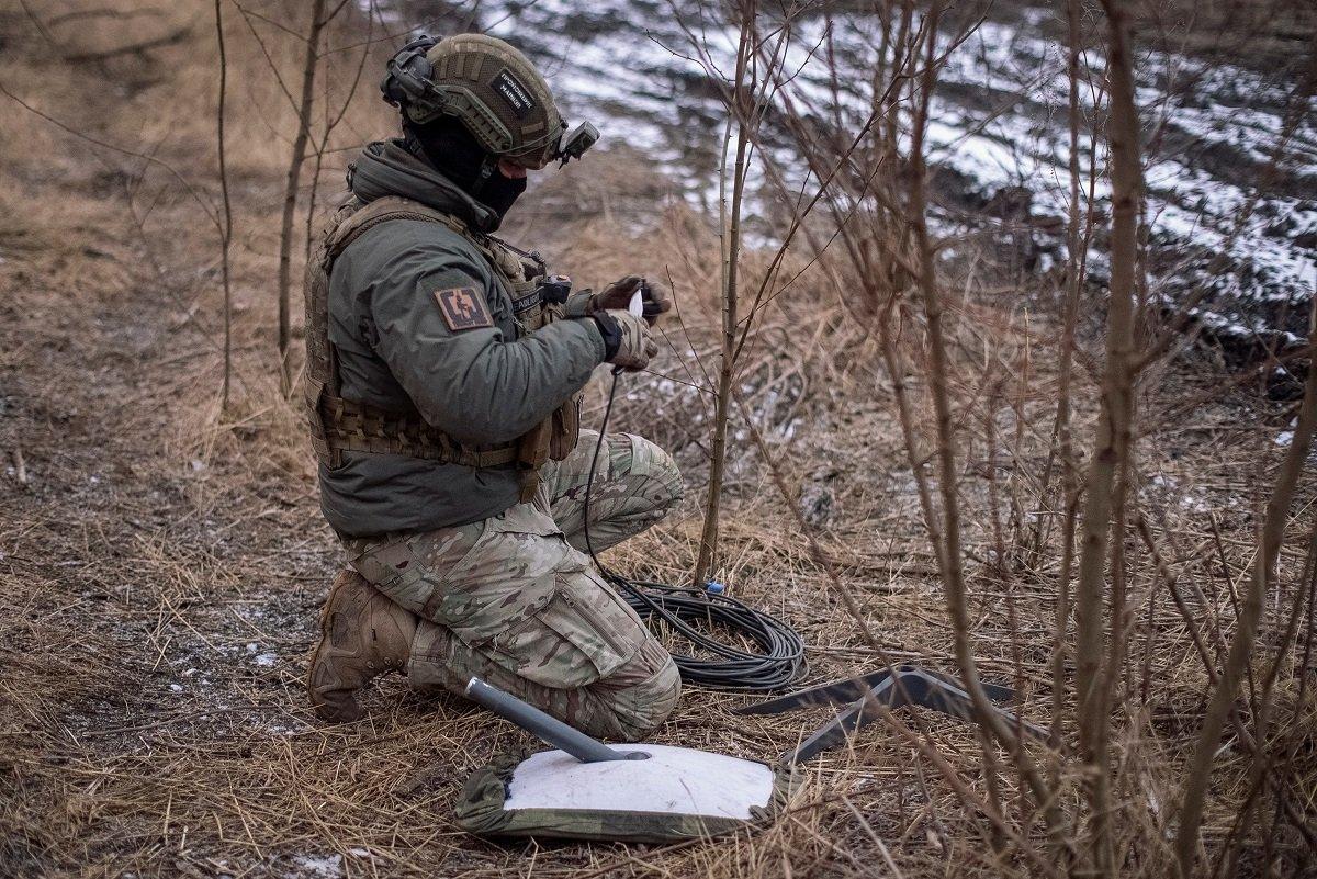 A Ukrainian soldier uses Starlink equipment near the front line of the war in February 2024