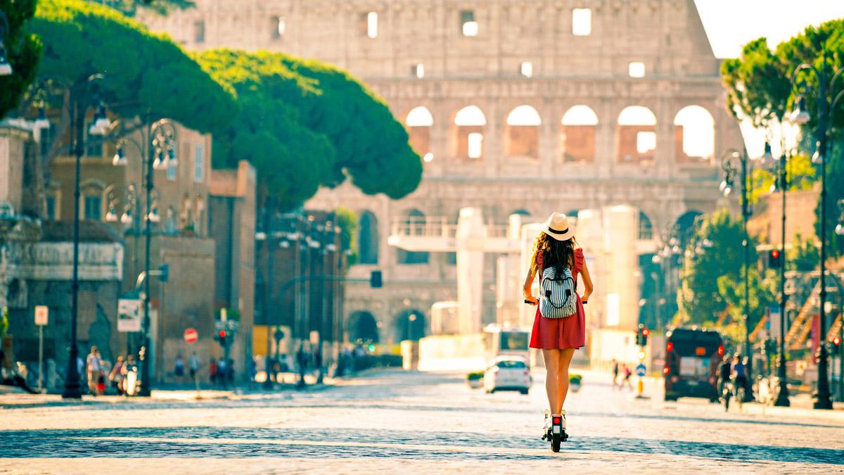 Young woman on electric scooter in Rome