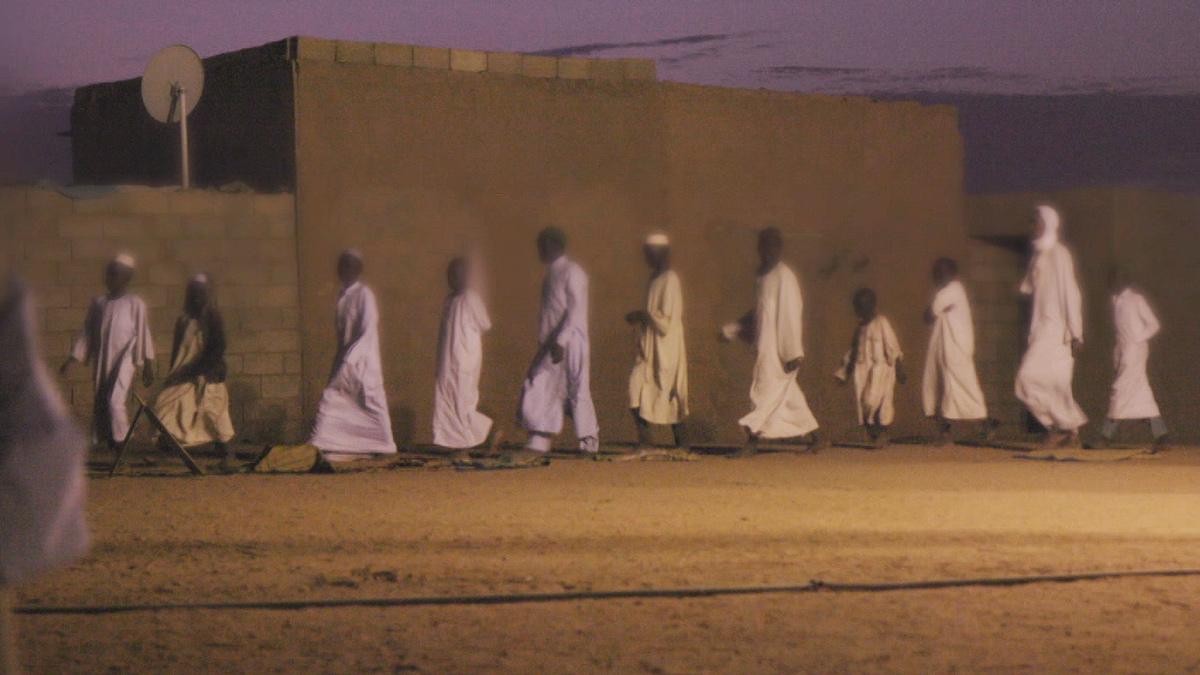 Boys in chains walking in a line