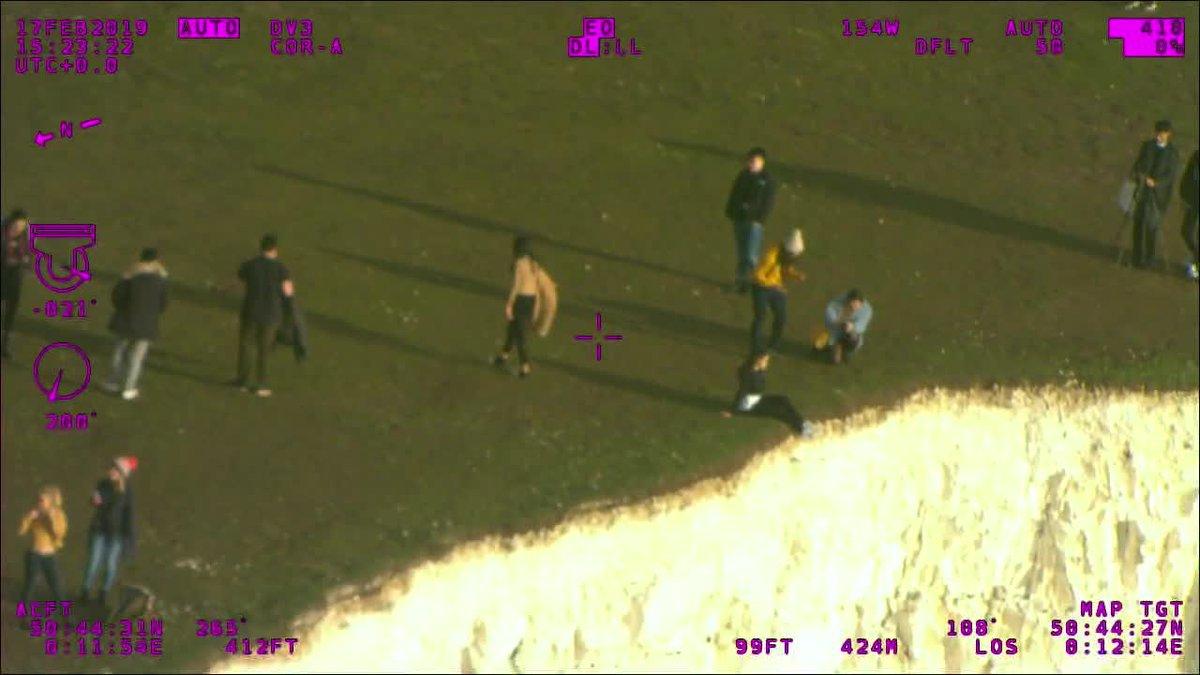 People near the edge of the cliffs at Beachy Head