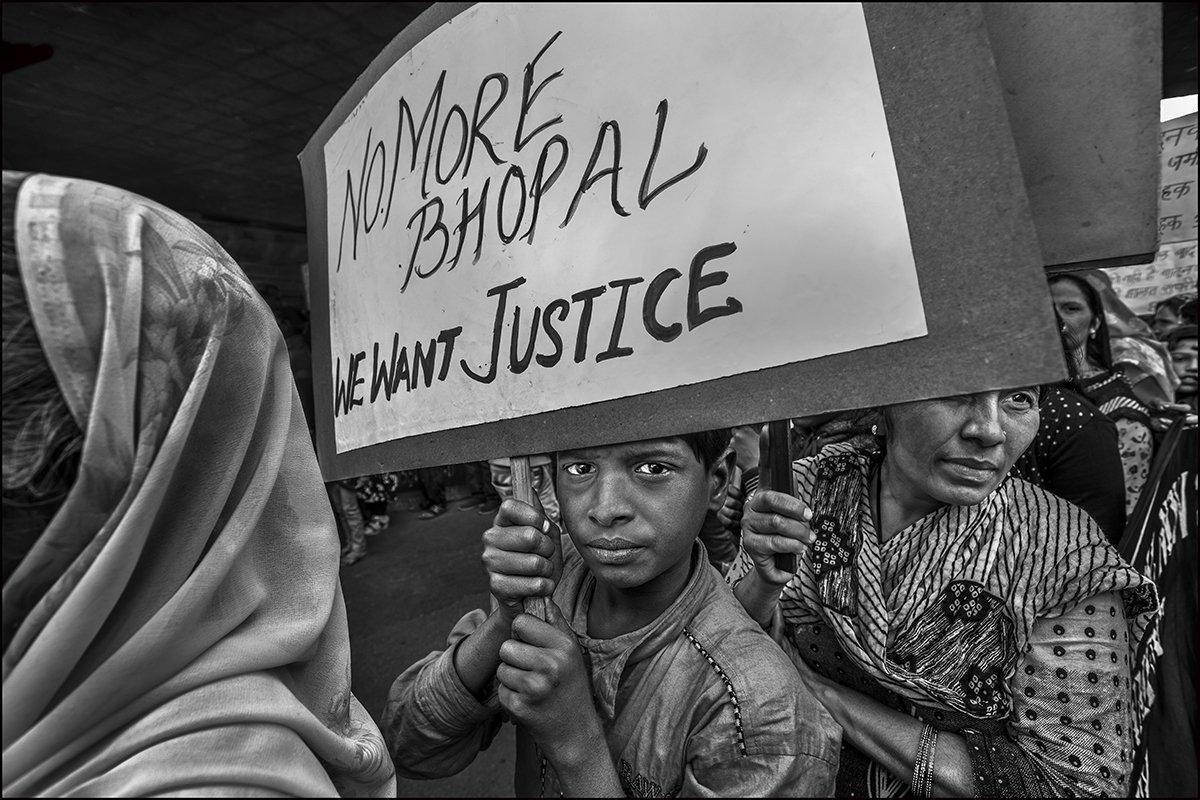 Demonstrators marching through the street of Bhopal to mark the 34th anniversary of the Union Carbide chemical plant disaster