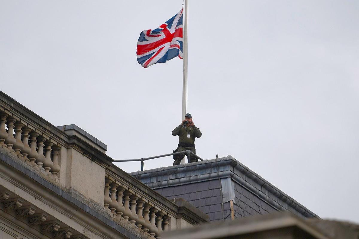 Armed police can be seen on rooftops