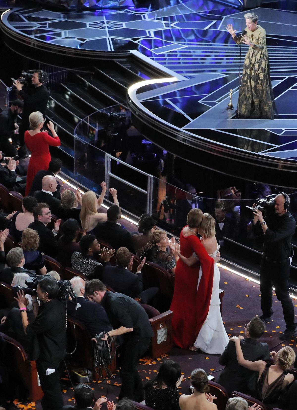 Frances McDormand stands on stage with her Oscar