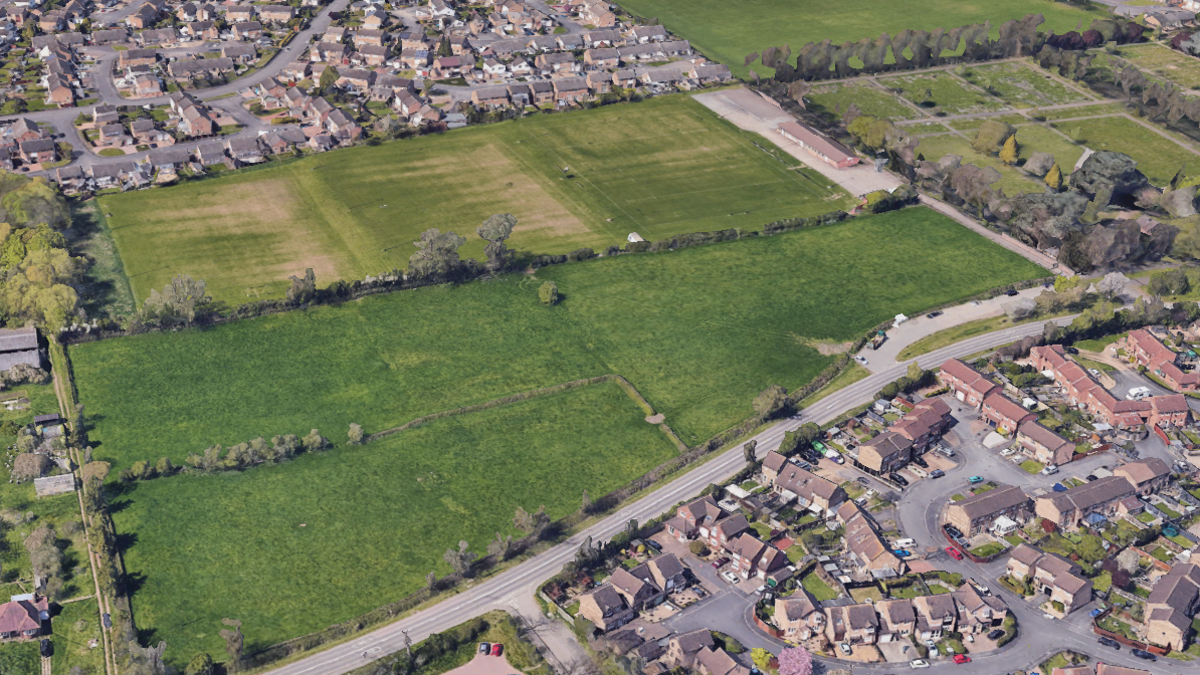 An aerial view of a field next to three rugby pitches.