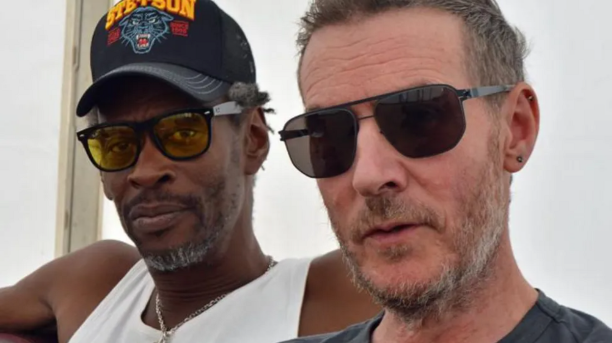 Massive Attack's Daddy G and 3D both wearing sunglasses, looking towards the camera