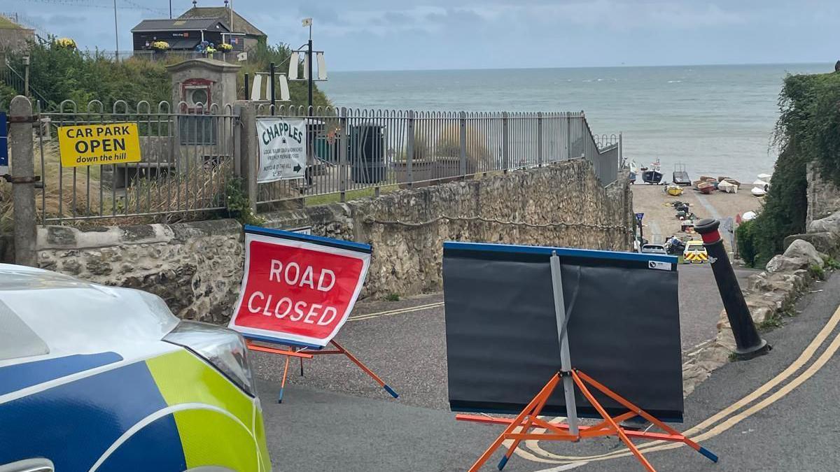 Police cordon and road closed sign at Beer beach